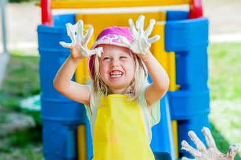 Child enjoying messy play with shaving cream during playgroup session