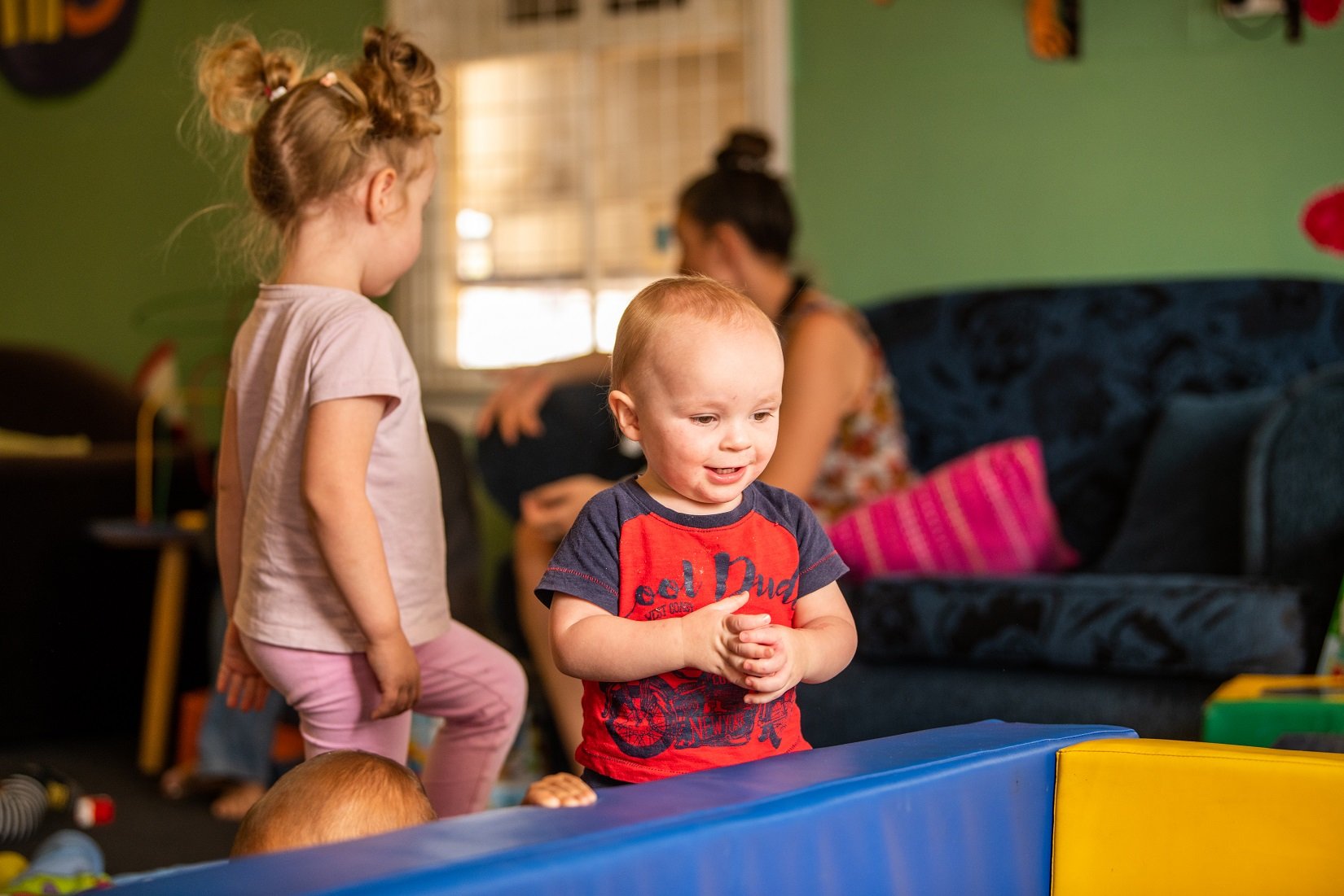 Child demonstrating onlooker play at a playgroup session