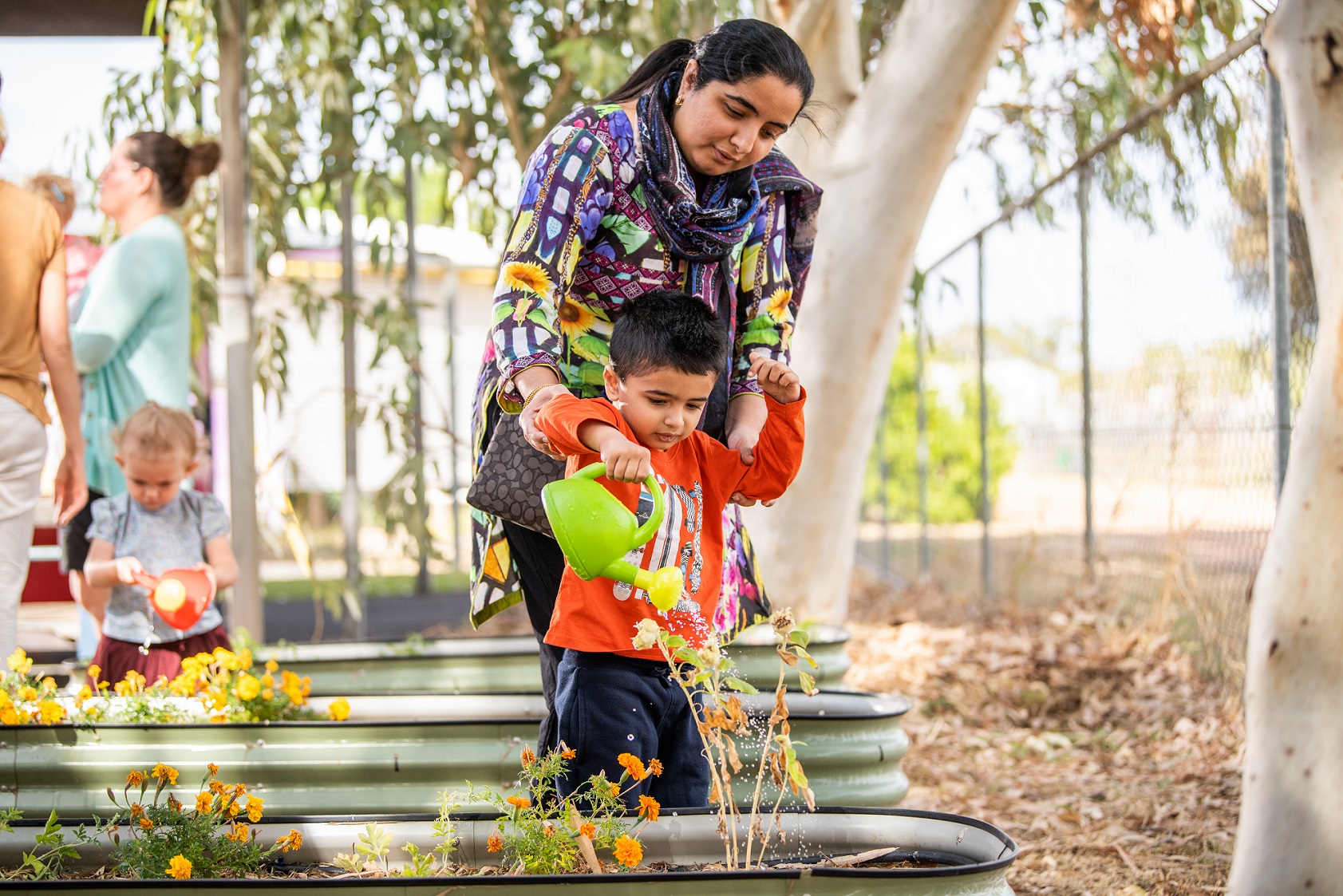 Mum and child watering