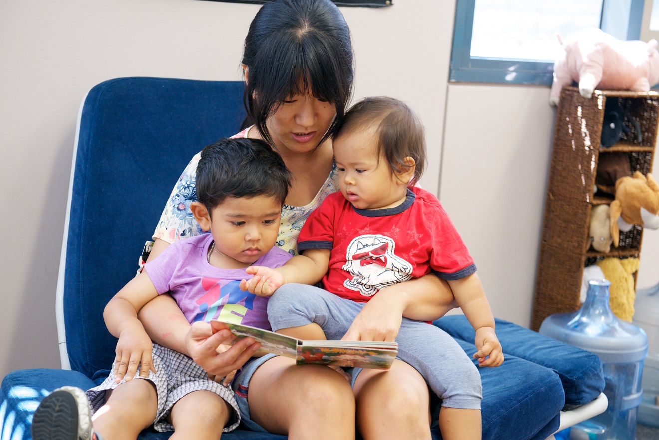Children reading with mother
