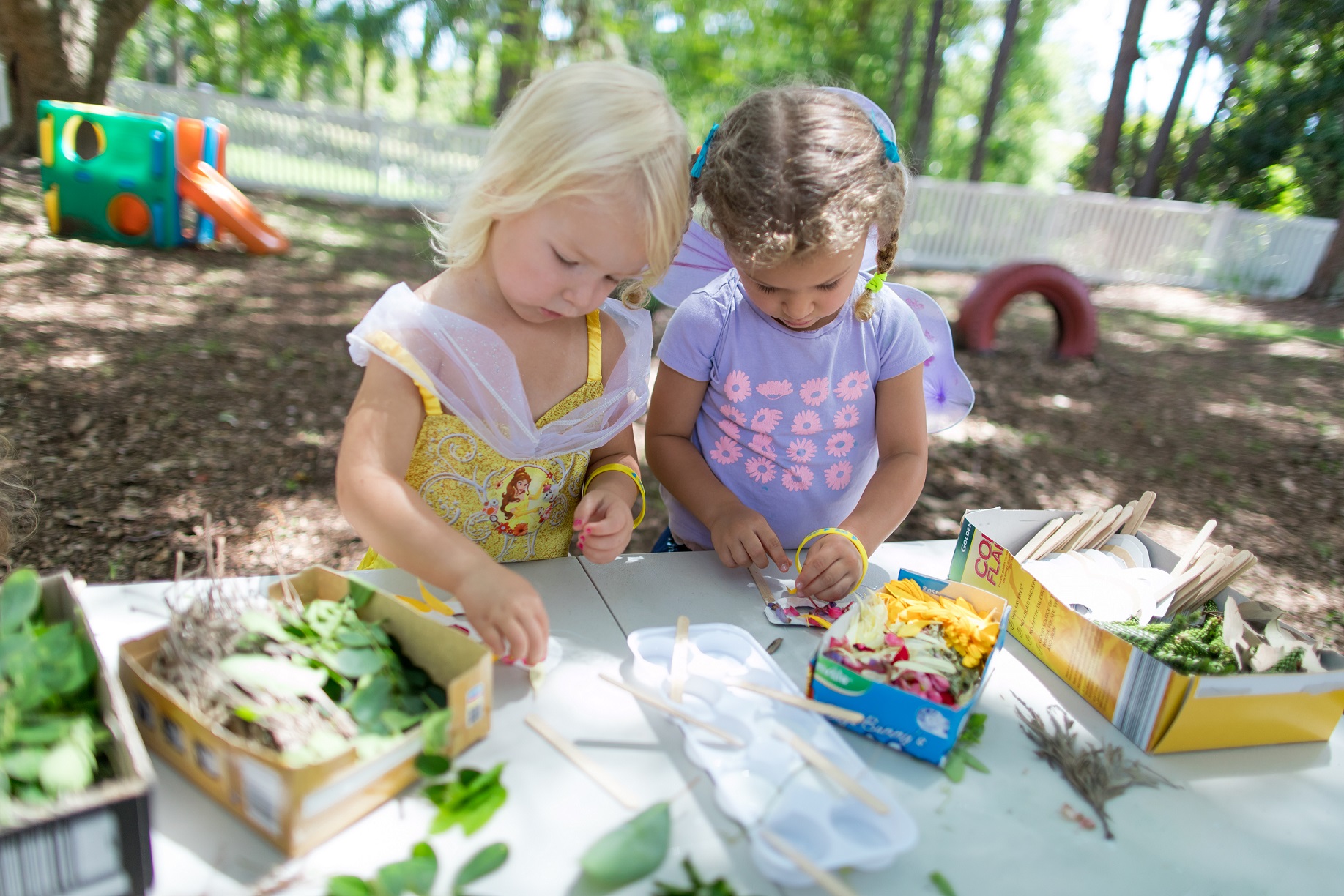 Two girls making masks