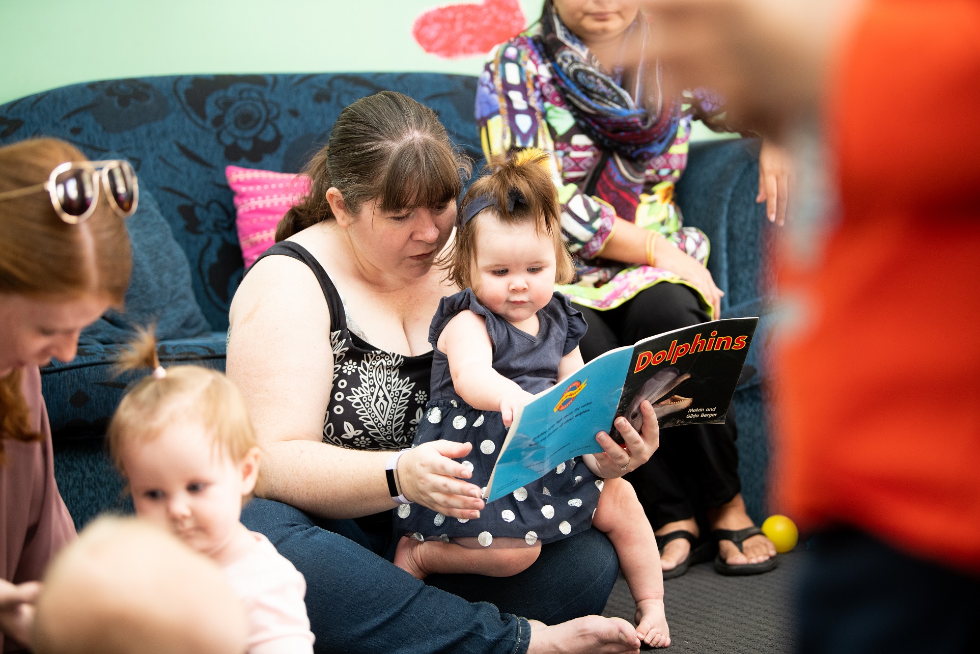 Child reading with mother